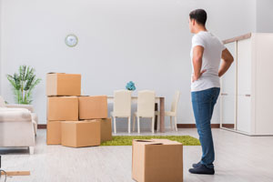 man looking at boxes in office